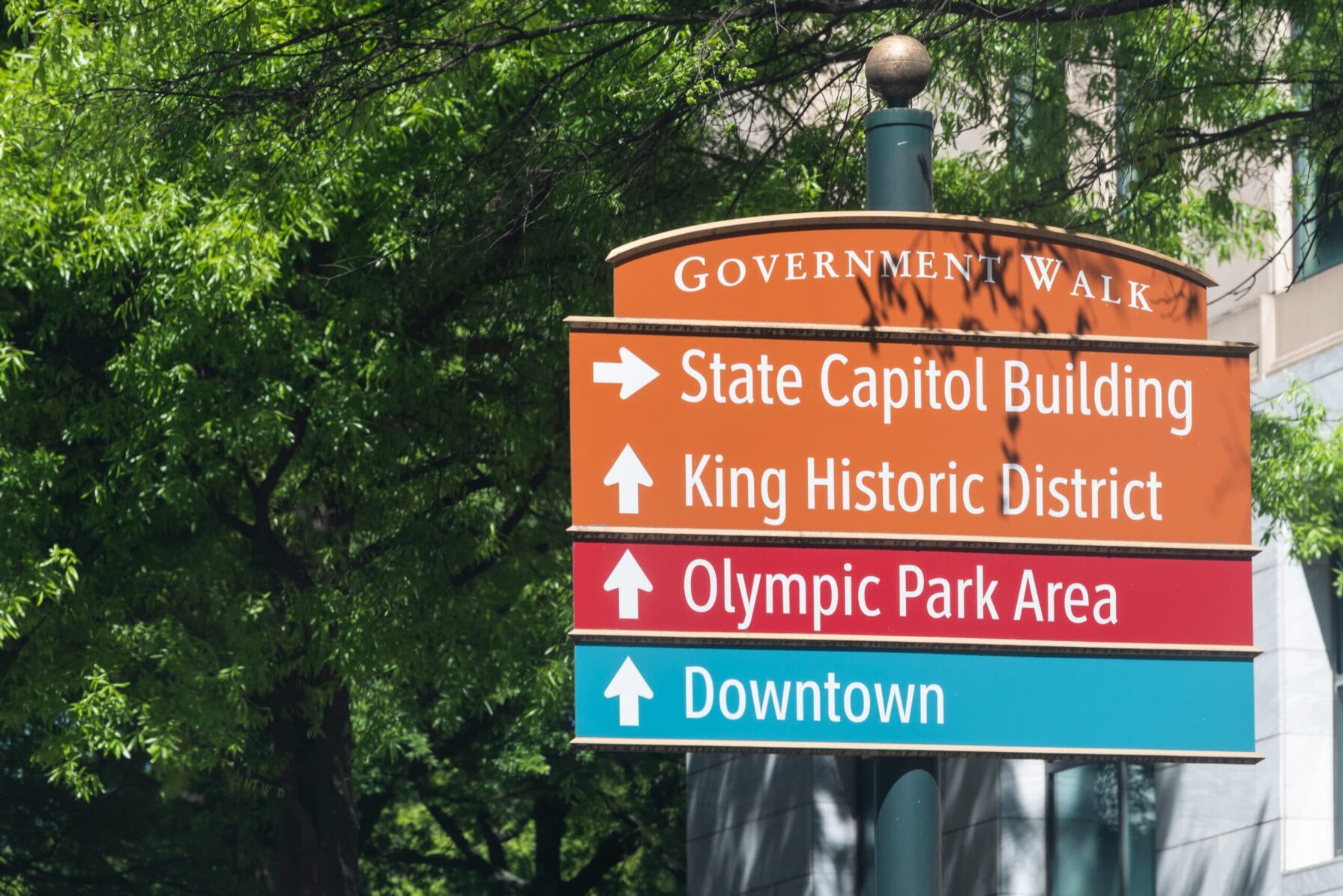 Atlanta, USA - April 20, 2018: Direction sign arrows to State Capitol Building, Government walk tour to Olympic Park area and King Historic Distrcit in downtown of Georgia city