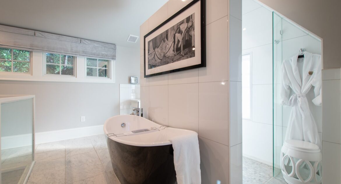 Fowler bathroom with glass walk-in shower with a white robe hanging on the wall