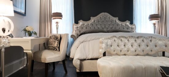 Fowler Suite view of sofa and desk with bed in the background in Stonehurst Place