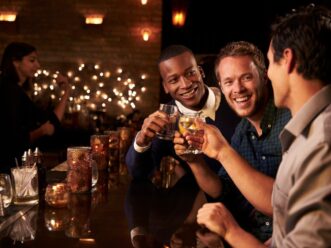 Three people drinking at an Atlanta gay club