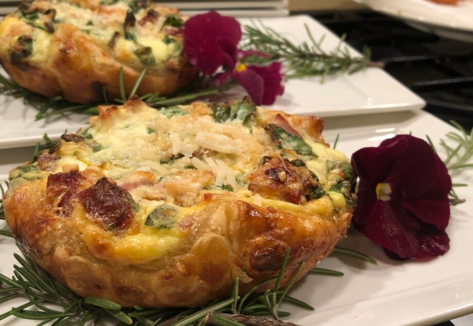 pastry with meat with rosemary and purple flower garnish on white dish at Stonehurst Place